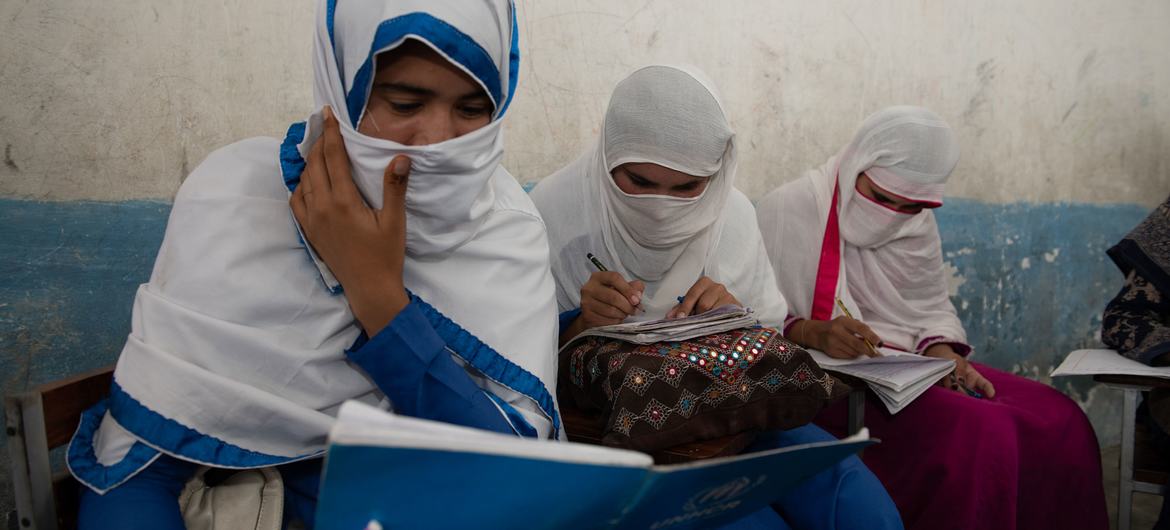 Young women who fled Afghanistan study in Pakistan. Young women who fled Afghanistan study in Pakistan.