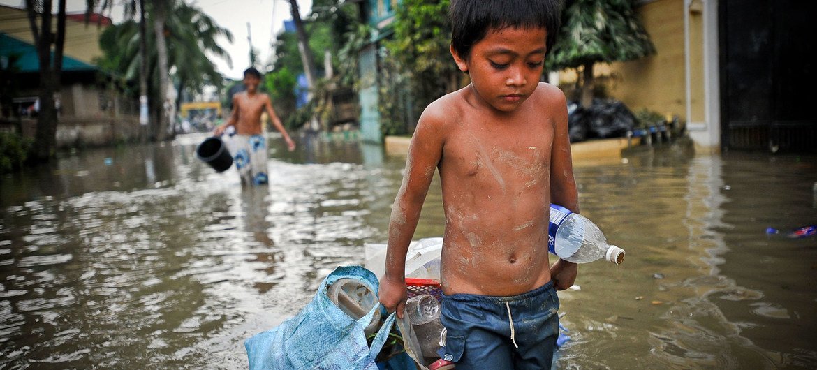 A boy drags possessions through the flooded streets of Manila in the aftermath of a typhoon. (file) A boy drags possessions through the flooded streets of Manila in the aftermath of a typhoon. (file)