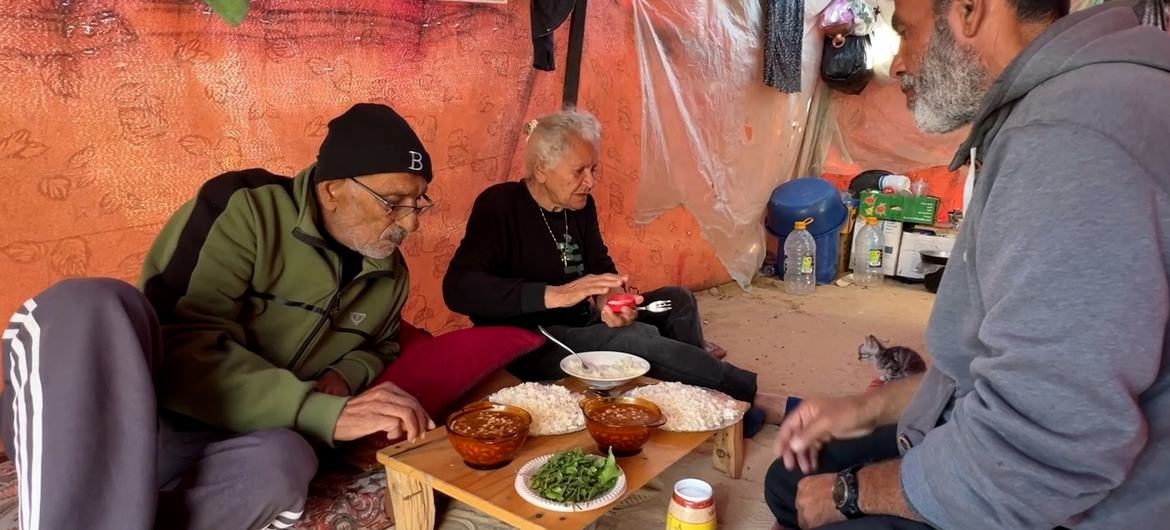 Uncle Tony with his wife, Amal, and their neighbour, Hossam, having dinner together Uncle Tony with his wife, Amal, and their neighbour, Hossam, having dinner together