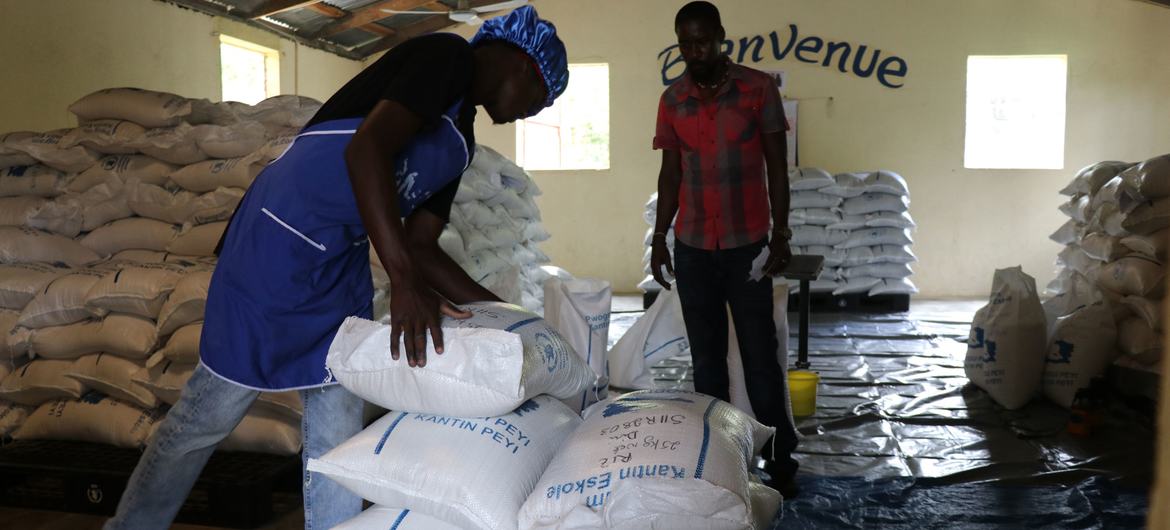 Workers in Haiti prepare humanitarian aid for distribution. Workers in Haiti prepare humanitarian aid for distribution.