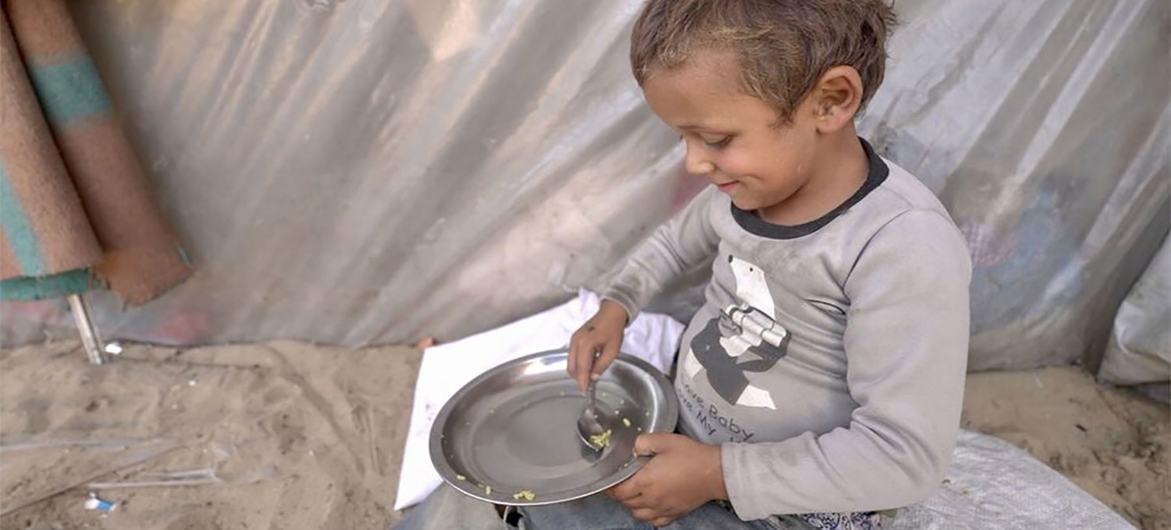 A small boy scoops up the last rice grains in his bowl. Hunger is soaring in Gaza and the WFP food allowed to enter is limited. A small boy scoops up the last rice grains in his bowl. Hunger is soaring in Gaza and the WFP food allowed to enter is limited.