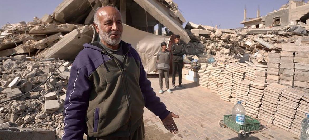 Abu Bilal shows his precarious shelter, built under two concrete slabs from his former apartment building. Abu Bilal shows his precarious shelter, built under two concrete slabs from his former apartment building.