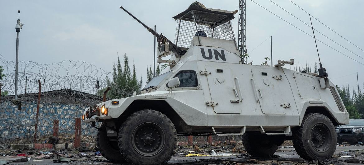 UN peacekeepers patrol in Goma past discarded military uniforms. UN peacekeepers patrol in Goma past discarded military uniforms.