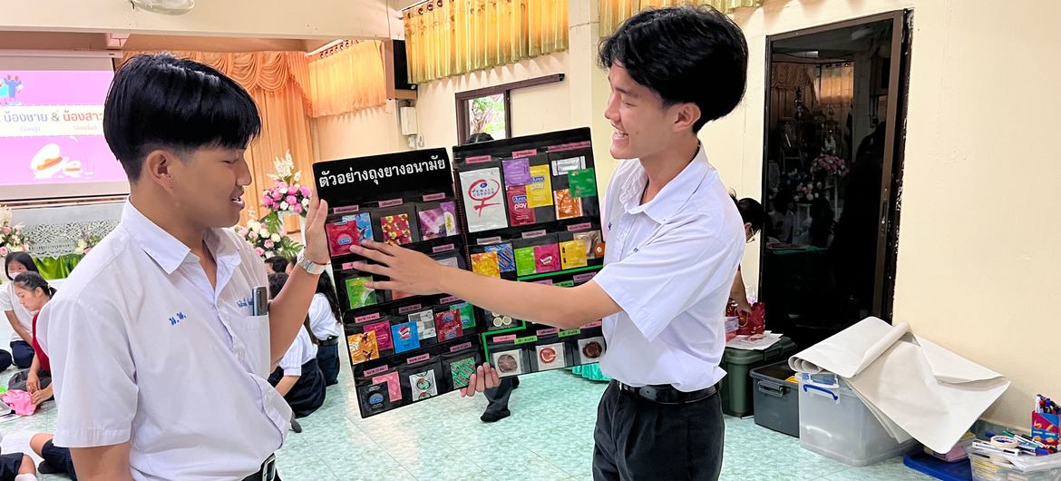 Two Thai peer educator high school students describe a range of available condoms. Two Thai peer educator high school students describe a range of available condoms.