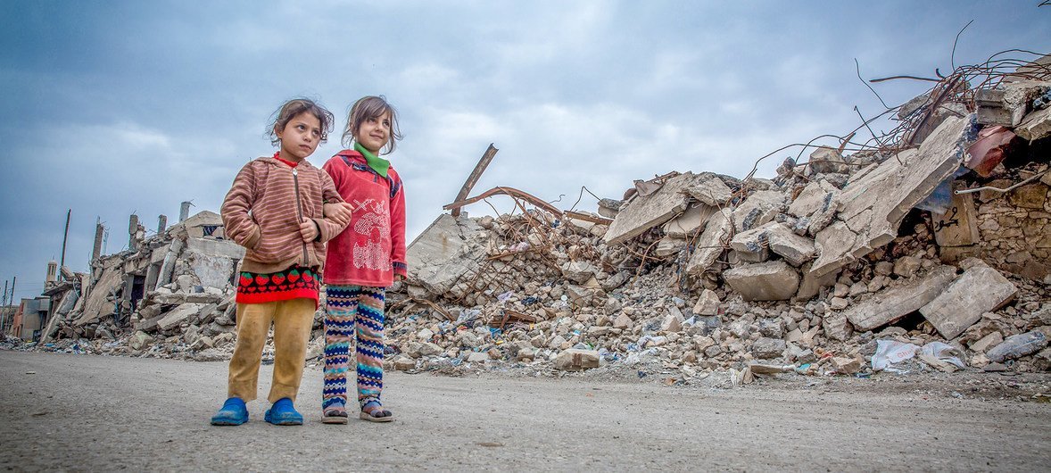 Two girls walk in the ruins of the city of Mosul. Two girls walk in the ruins of the city of Mosul.