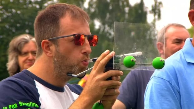 A Participant in the World Pea Shooting Championship A Participant in the World Pea Shooting Championship