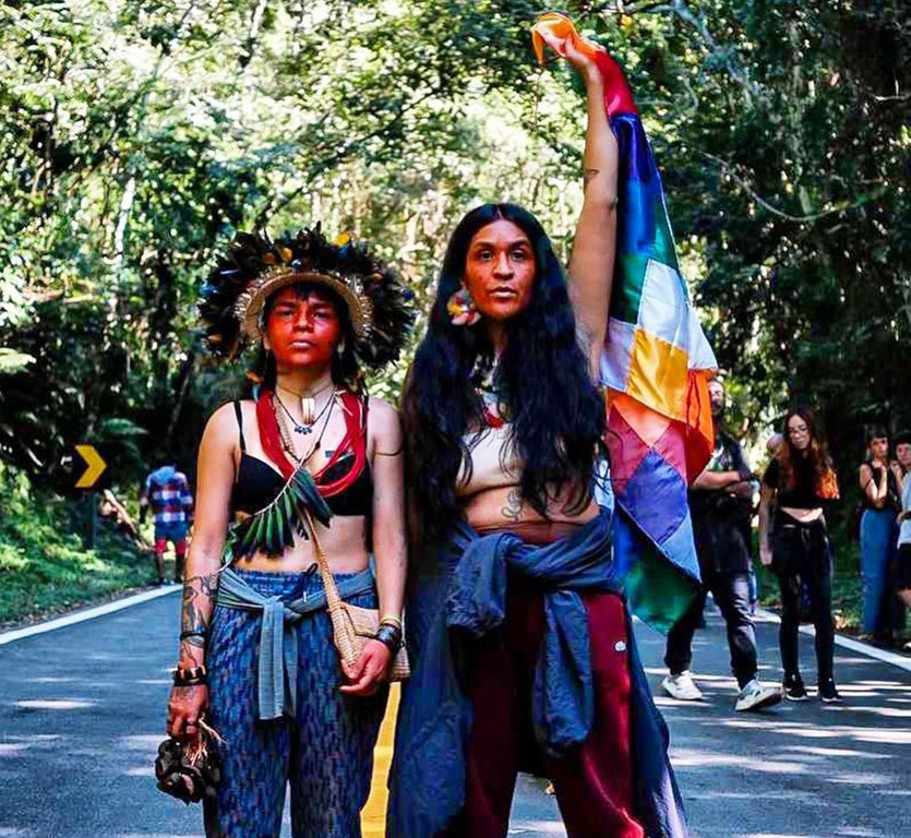 Ms. Flow (right) at a protest by the Guarani people of Brazil. Ms. Flow (right) at a protest by the Guarani people of Brazil.