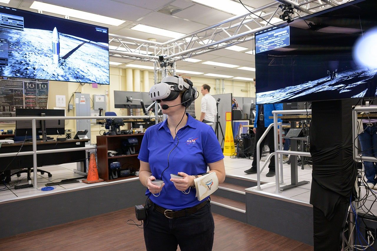 Tess Caswell, a test subject crew member for the Artemis III Virtual Reality Mini-Simulation, executes a moonwalk in the Prototype Immersive Technology (PIT) lab at NASA’s Johnson Space Center in Houston. The simulation was a test of using VR as a training method for flight controllers and science teams’ collaboration on science-focused traverses on the lunar surface. Credit: NASA/Robert Markowitz