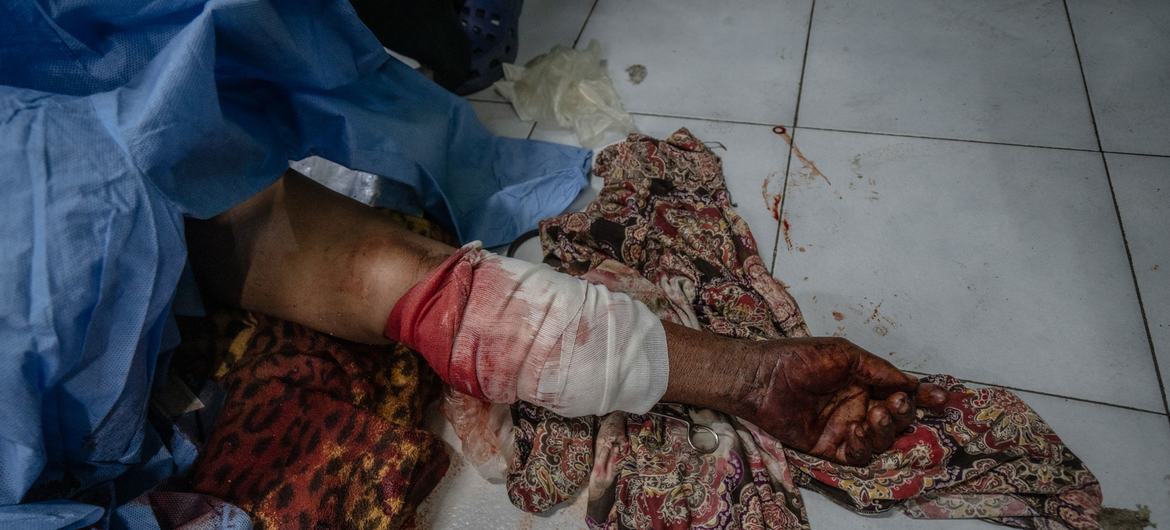 A 63-year-old woman lies wounded on the floor of a hospital in Port-au-Prince after warring gangs swept through her neighborhood. A 63-year-old woman lies wounded on the floor of a hospital in Port-au-Prince after warring gangs swept through her neighborhood.
