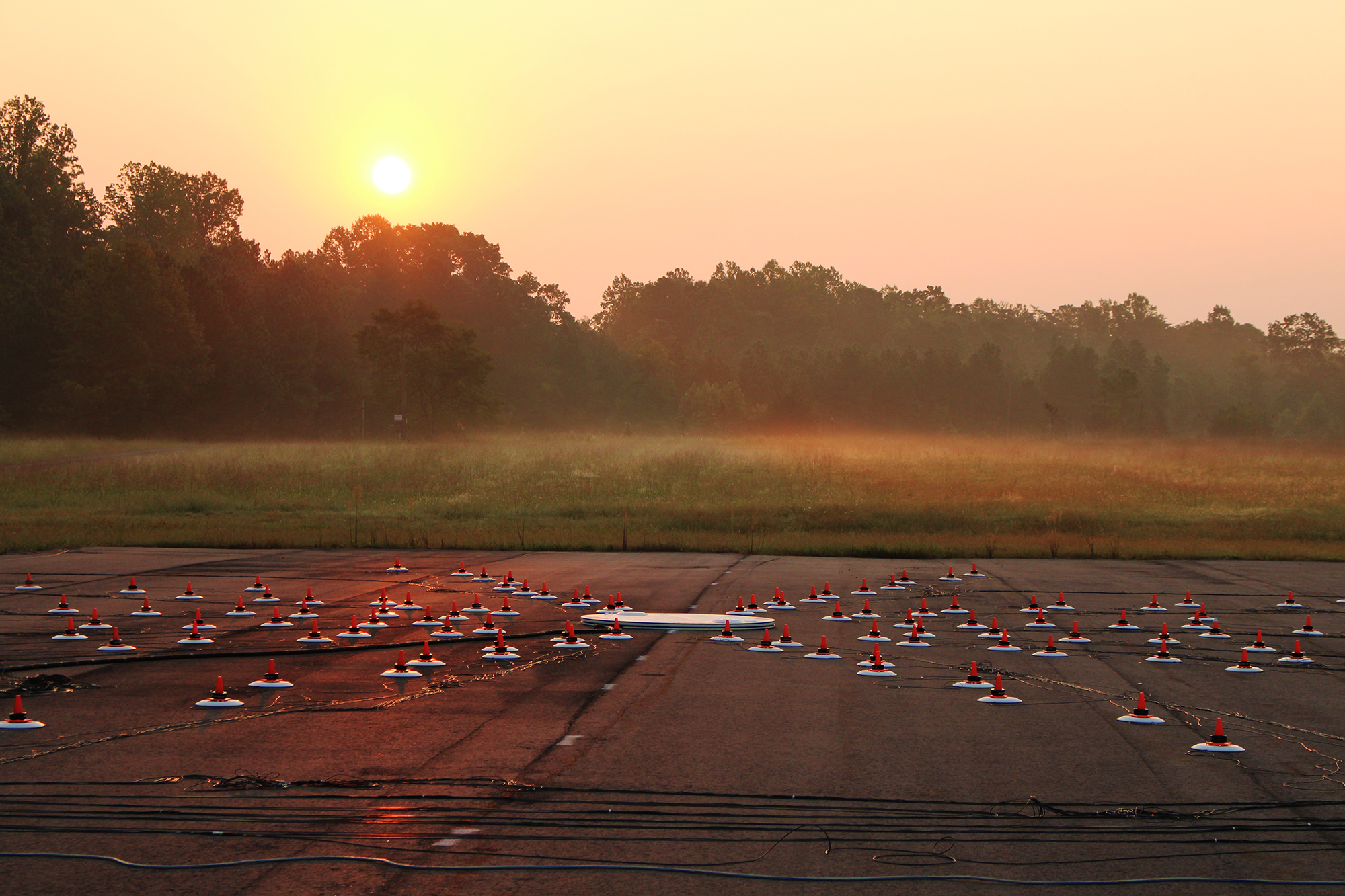 At twilight, an array of microphones test flight noise