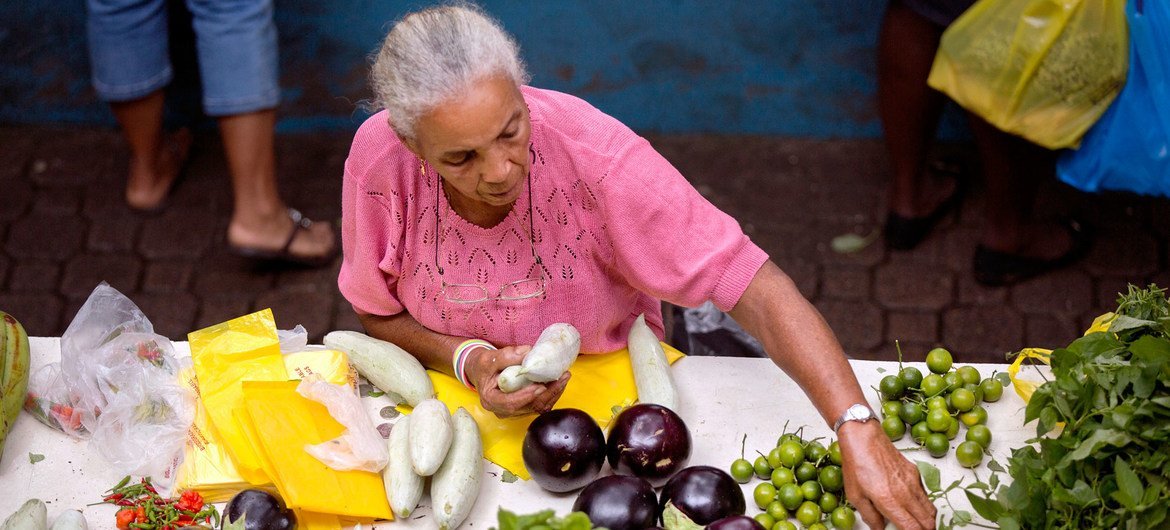 A woman sells vegetables in a market in Seychelles. Despite ongoing efforts, progress toward achieving several SDGs — including those on women's empowerment – remains off track for 2030. A woman sells vegetables in a market in Seychelles. Despite ongoing efforts, progress toward achieving several SDGs — including those on women's empowerment – remains off track for 2030.