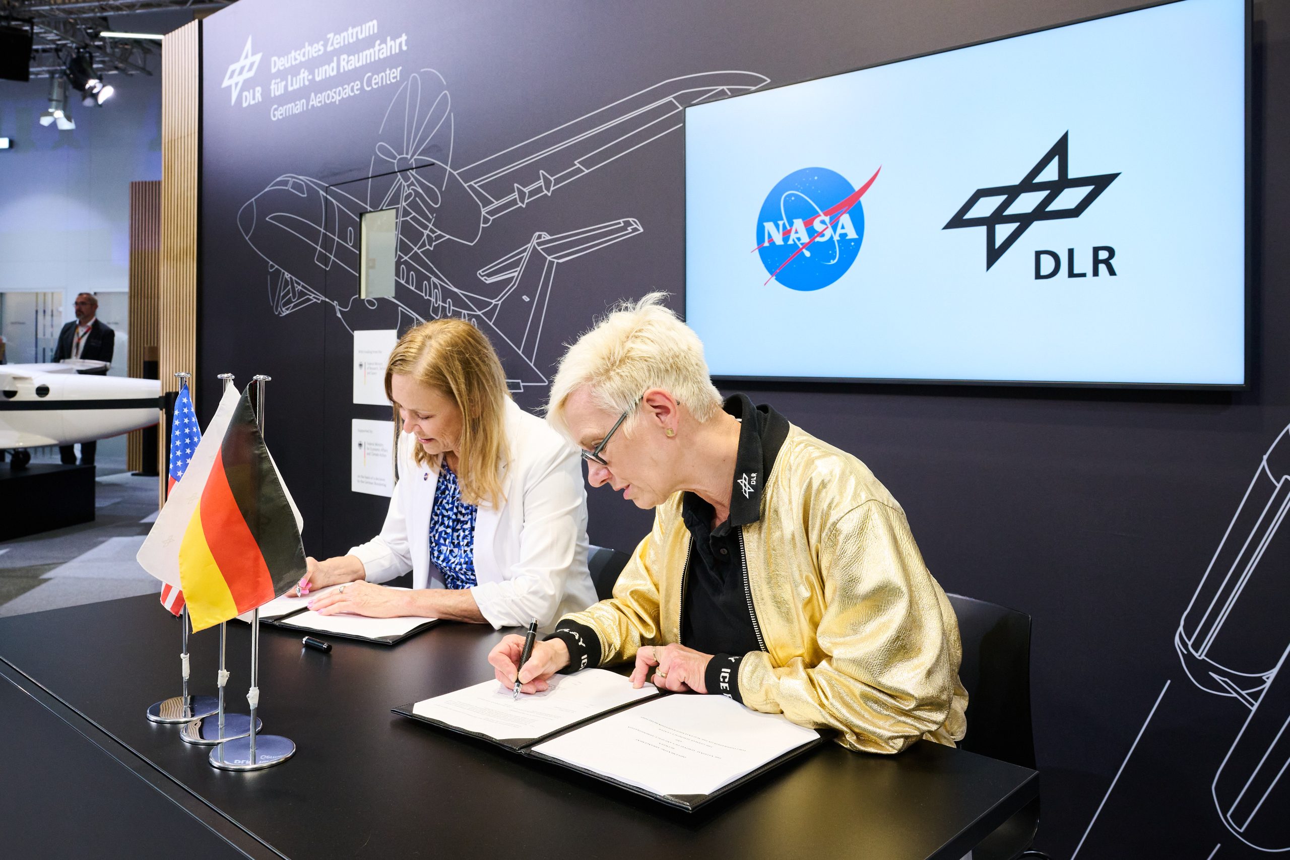 NASA acting administrator Janet Petro signs agreement with German Space Agency.