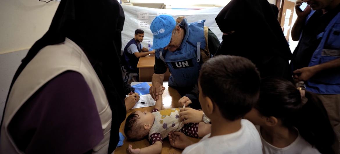 Dr. Younis Awadallah administers a polio vaccine in Gaza. Dr. Younis Awadallah administers a polio vaccine in Gaza.