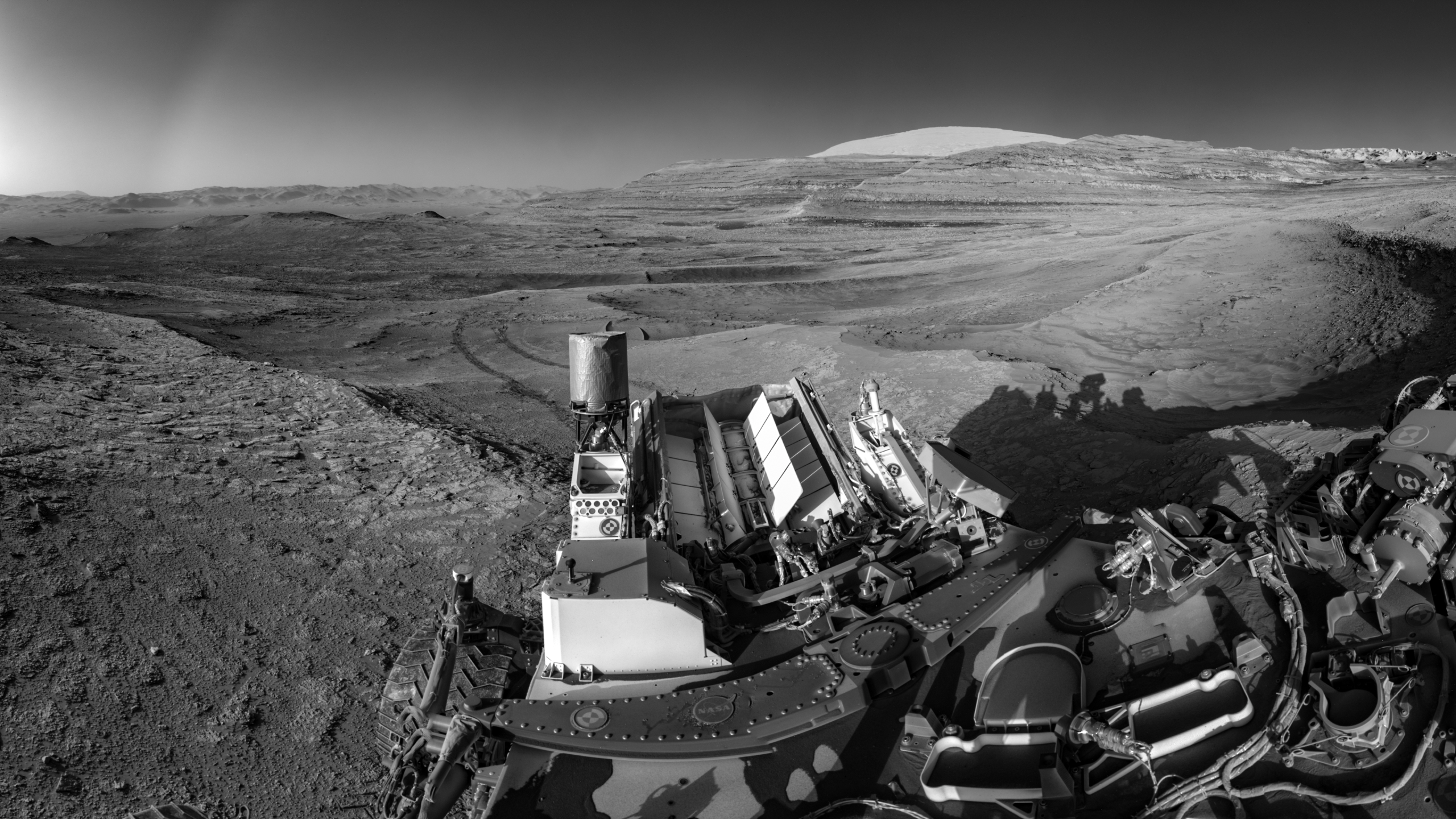 This view of tracks trailing behind NASA’s Curiosity was captured while the rover simultaneously relayed data to a Mars orbiter.