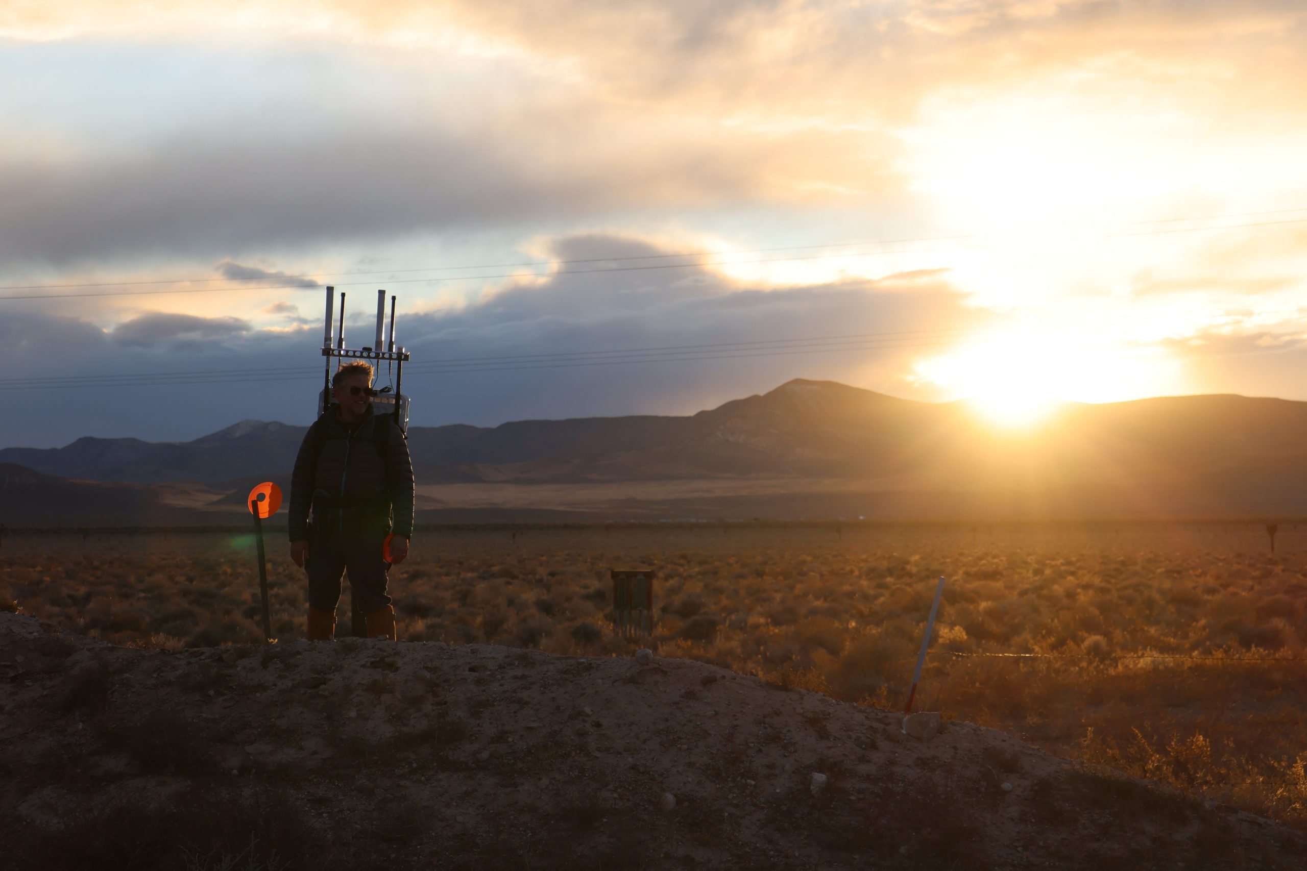 A person walks with a prototype backpack in the Nevada desert.