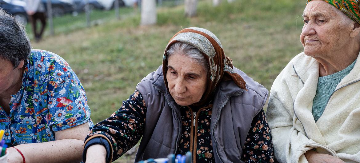 Ana (centre) sits alongside other elderly women who have sought support at the centre in Chișinău.
