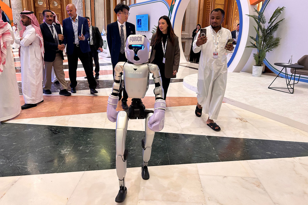 An AI-enabled humanoid robot walks the corridors of the 2025 UNIDO Global Industry Summit in Riyadh, Saudi Arabia.