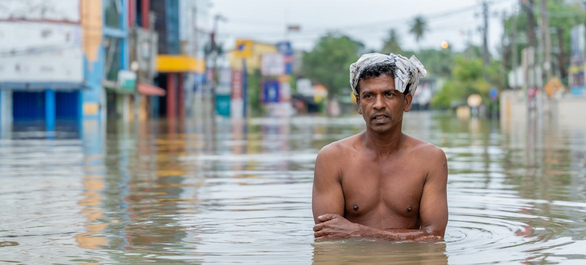 A man stands in over three feet of floodwaters in Gampaha, Sri Lanka. A man stands in over three feet of floodwaters in Gampaha, Sri Lanka.