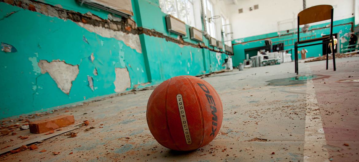 A basketball lies in a school gymnasium which was damaged during heavy shelling in the Kherson region of Ukraine.