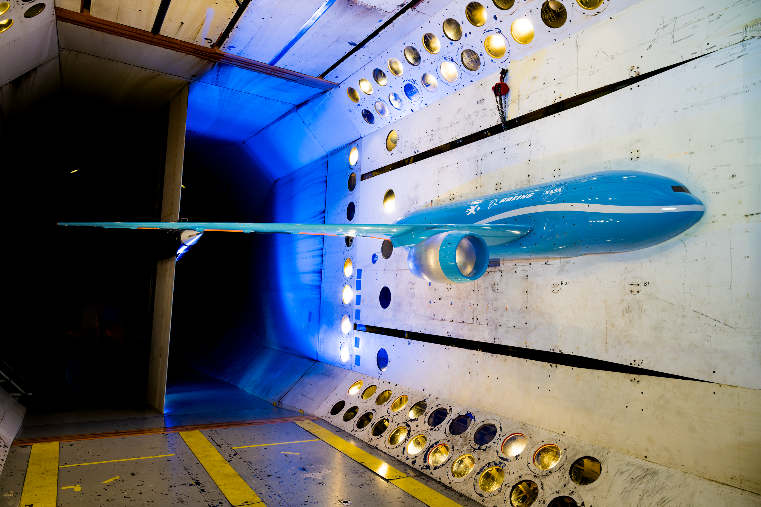 A scale model of possible future commercial jet airplane sits inside a NASA wind tunnel where the aircraft wing was tested.