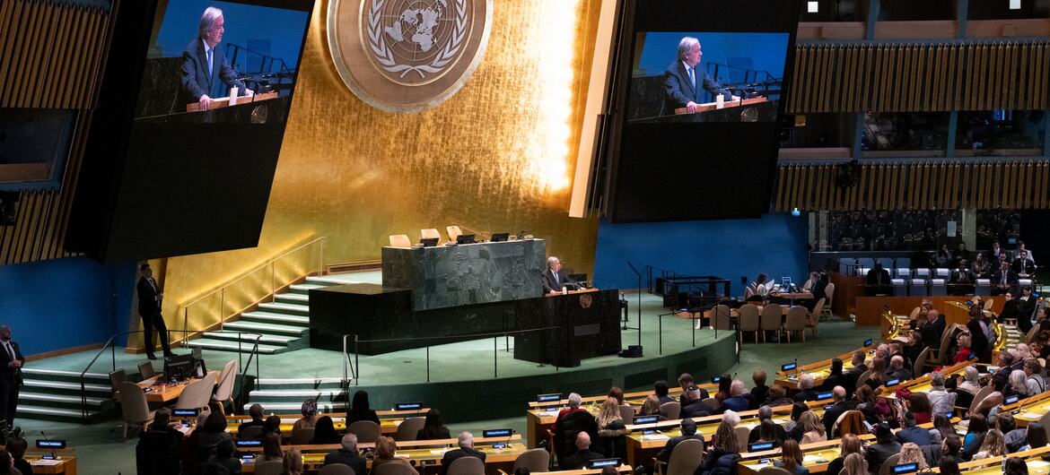 Secretary-General António Guterres addresses the United Nations Observance of International Day of Commemoration in memory of Holocaust victims, with large screens displaying him at the podium and delegates seated in the hall.