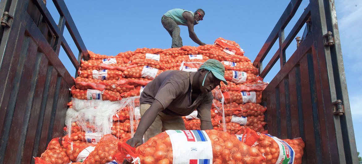 Men unload sacks of onions from a truck in Bamako, Mali, a landlocked developing country. Their lack of direct access to the vital trade links often result in landlocked countries paying high transport and transit costs.